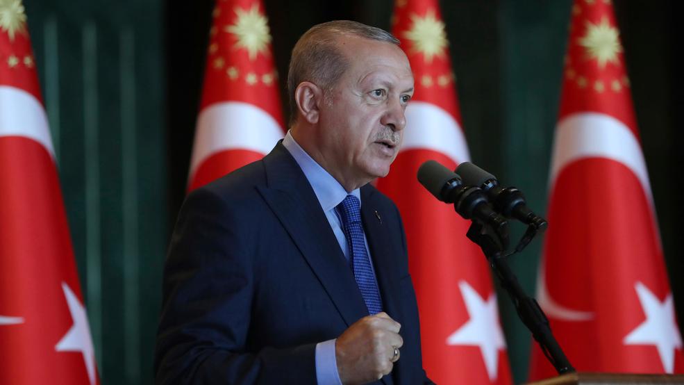 Image result for Turkey's President Recep Tayyip Erdogan, gestures as he delivers a speech to Turkish ambassadors at the Presidential Palace in Turkey, Monday, Aug. 13, 2018. Erdogan says his country is under an economic "siege" that has nothing to do with its economic indicators. He insisted that Turkey's economic dynamic remain strong and said the Turkish currency would soon settle "at the most reasonable level."